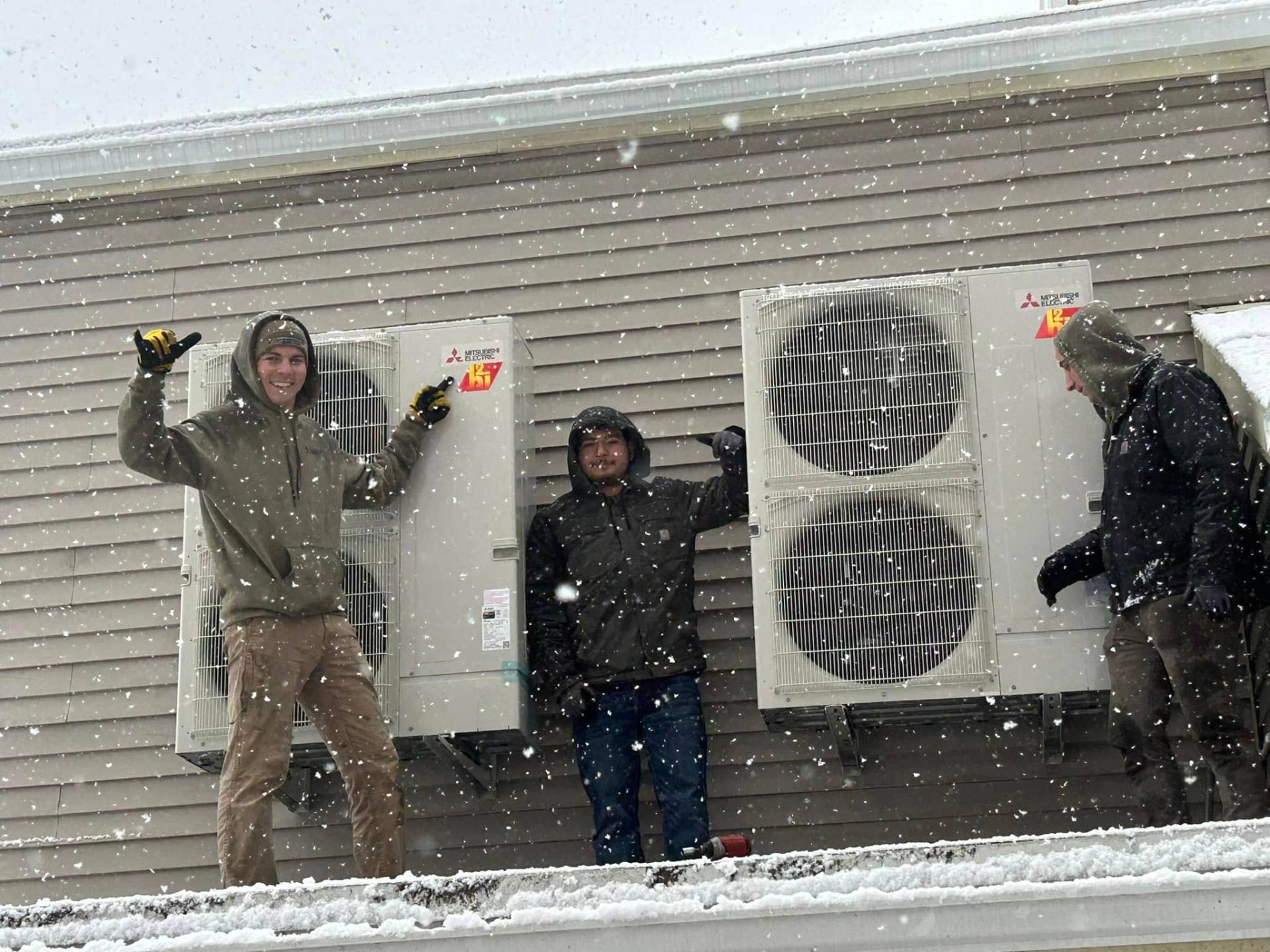 Fong & Sullivan team installing heat pumps on a roof