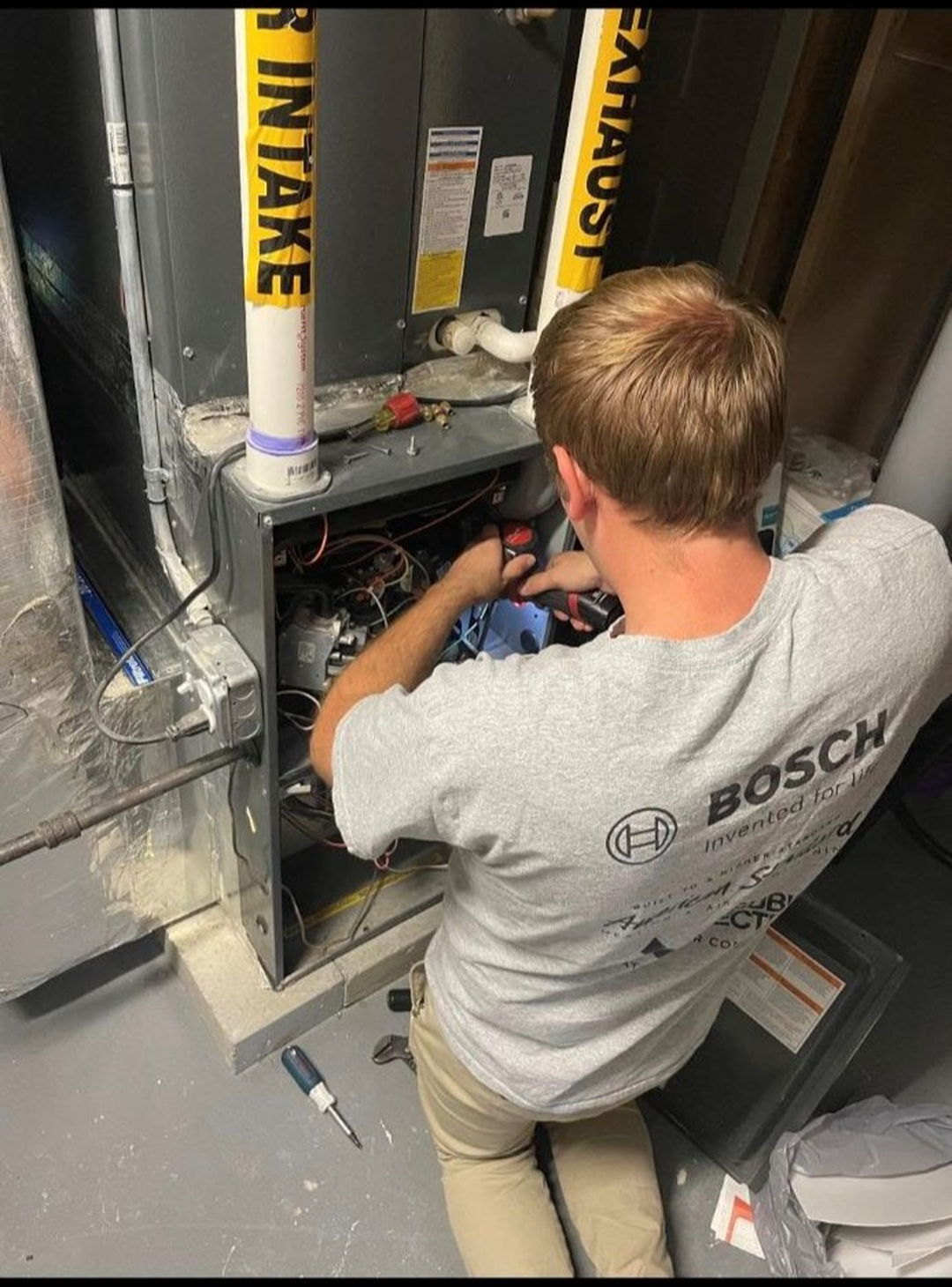 Technician explaining furnace repair to homeowner